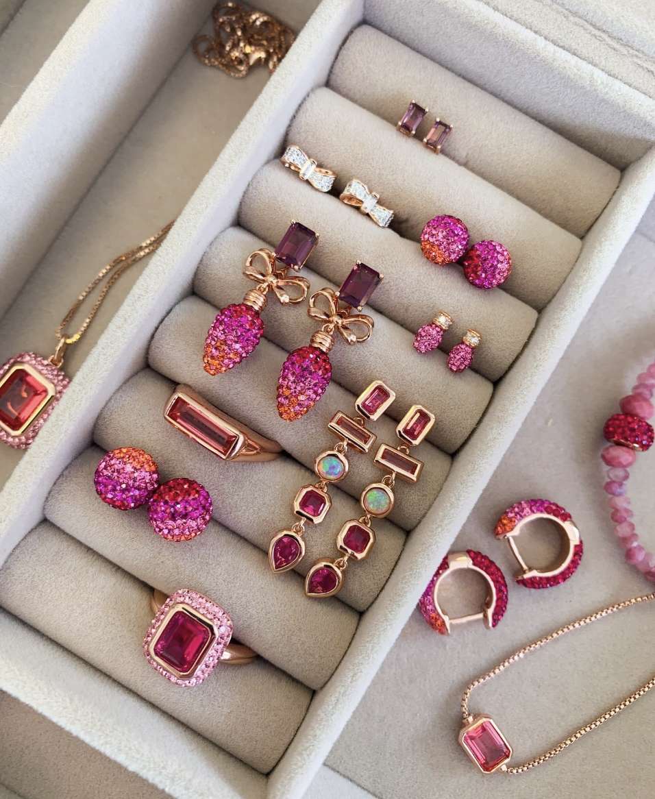 A collection of pink and sparkly earrings and rings and necklaces.