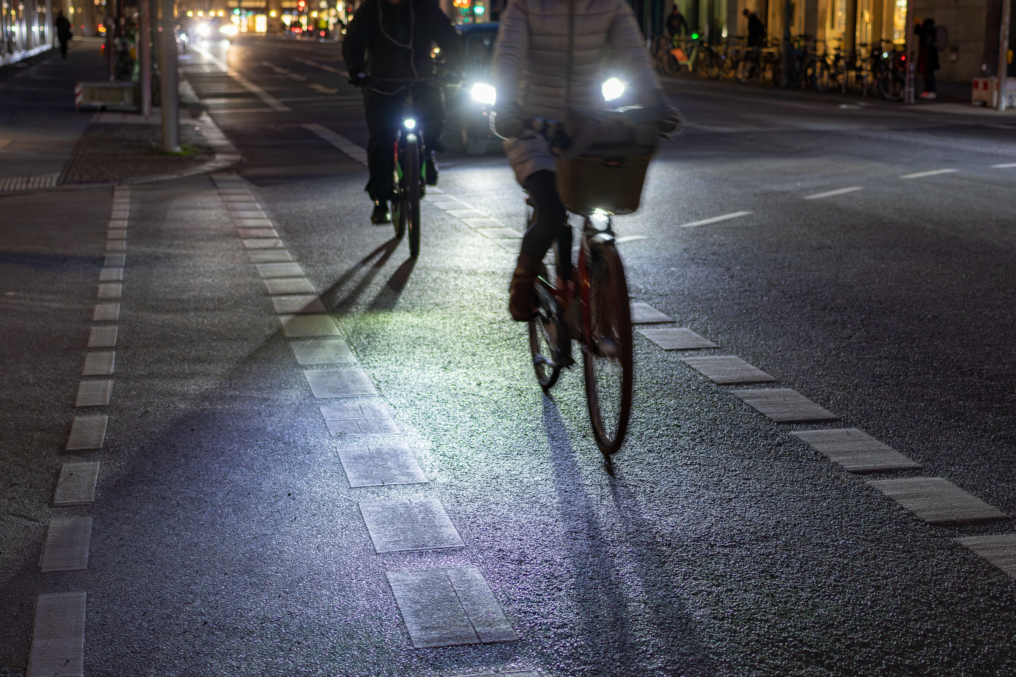 people riding bikes at night