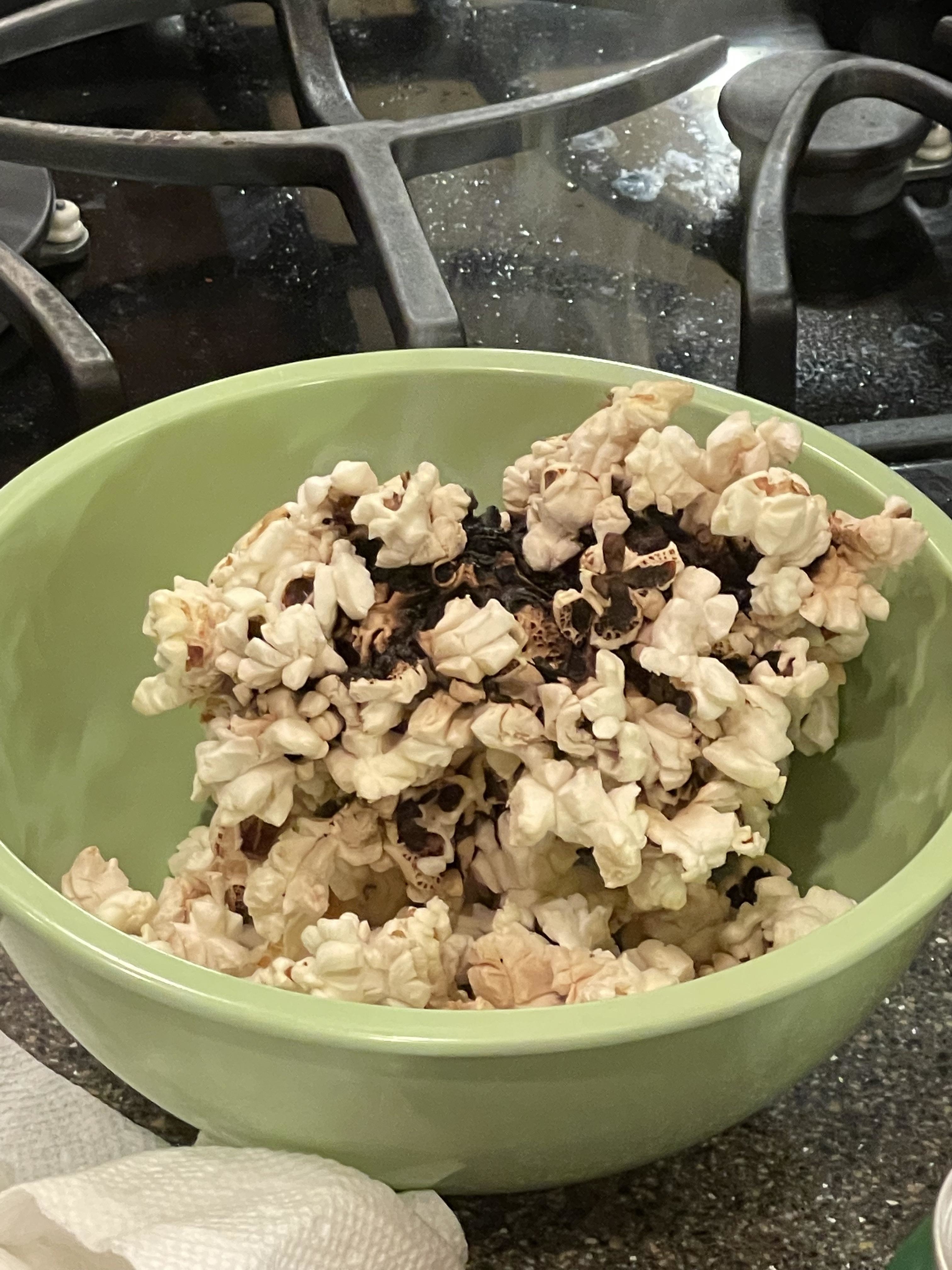 a bowl of burnt popcorn
