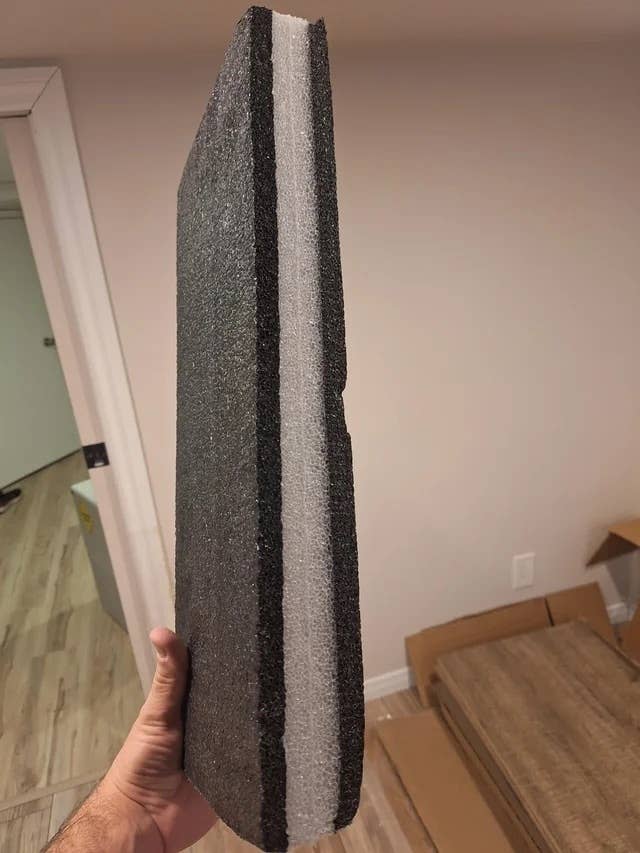 a black and white piece of foam packaging