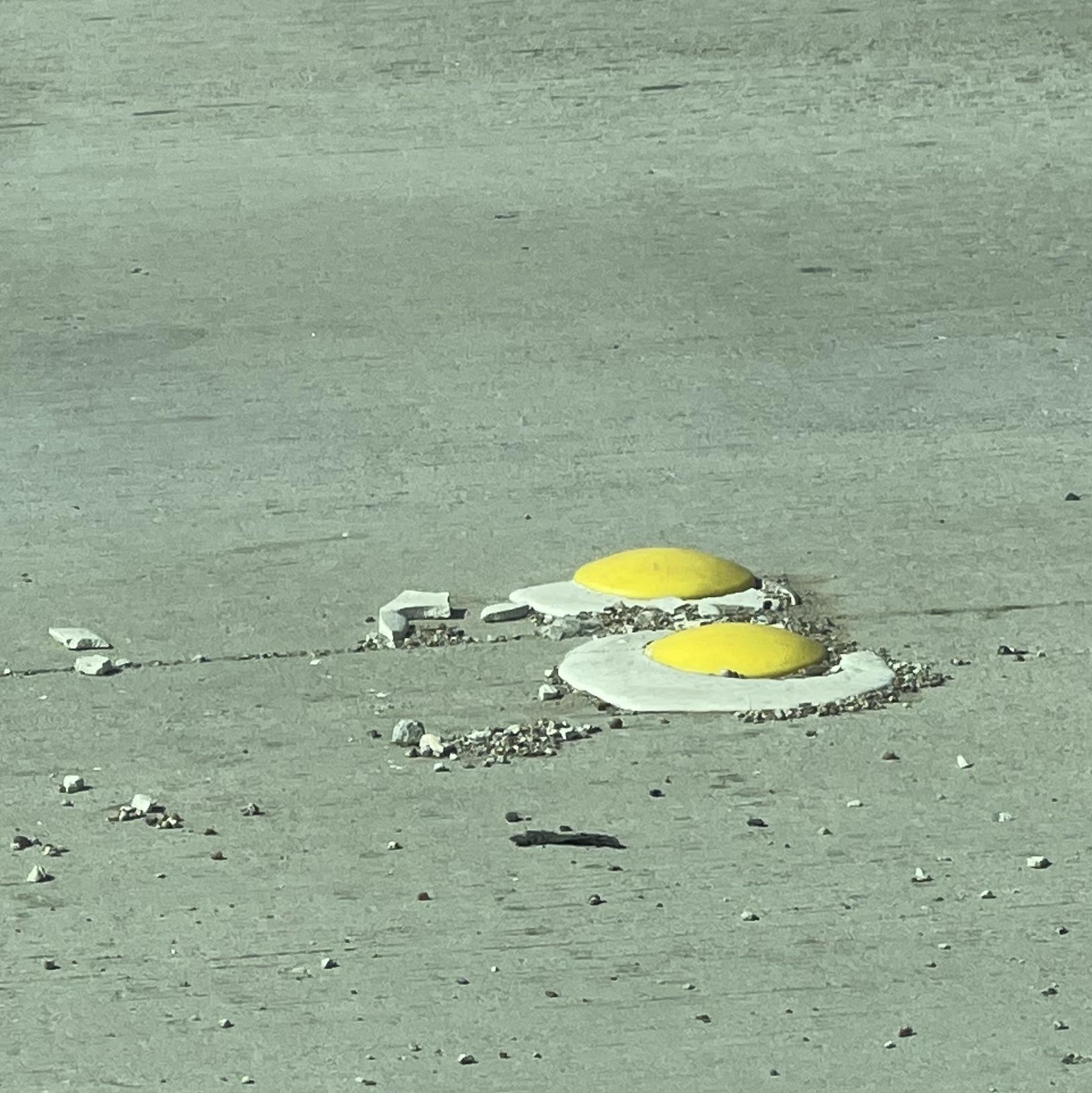 concrete lane dividers that look like sunny side up eggs