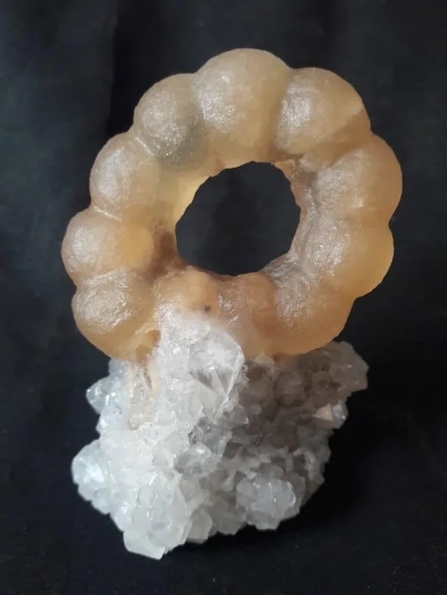 a mochi donut shaped mineral embedded in another mineral