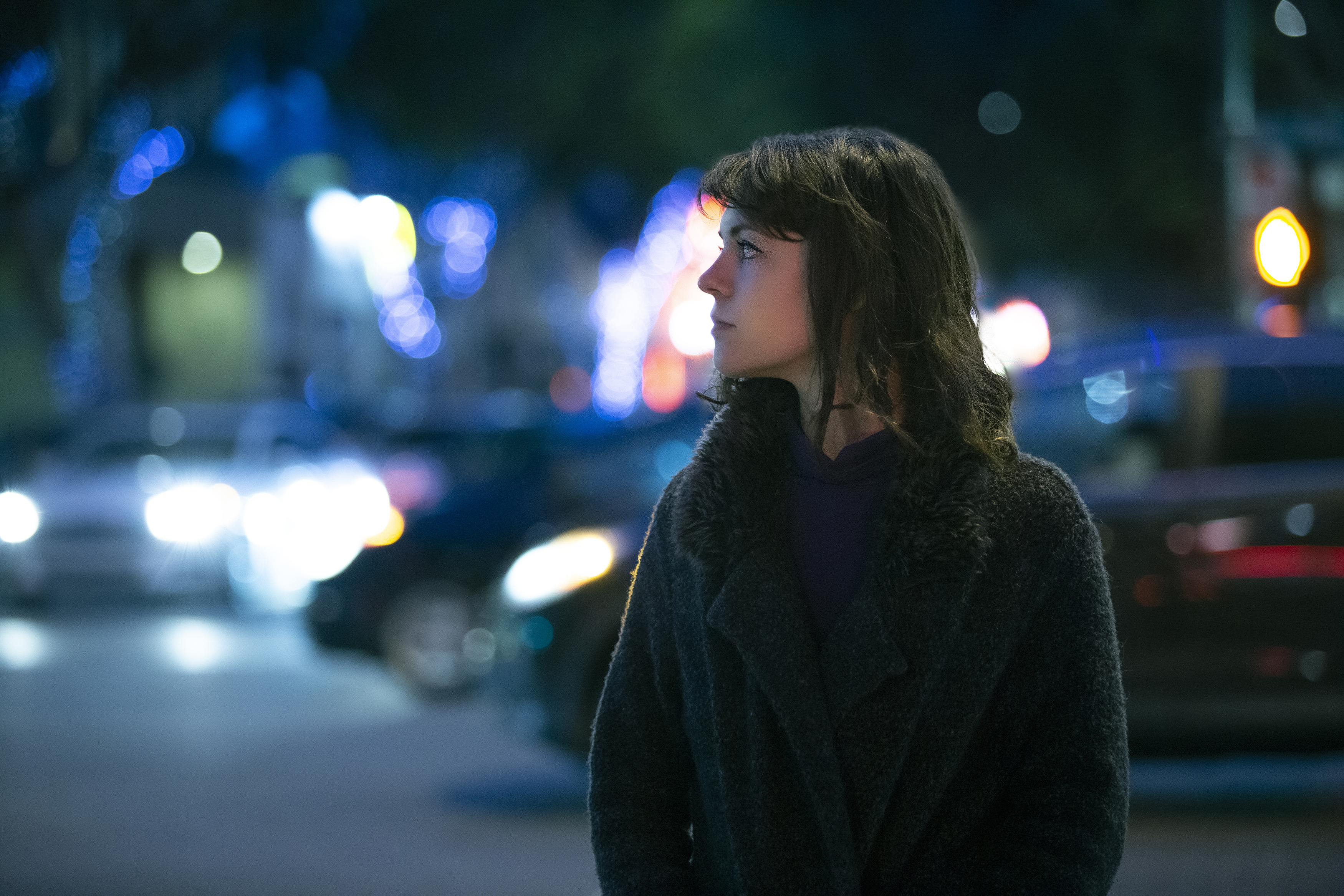 woman walking alone at night looks over her shoulder