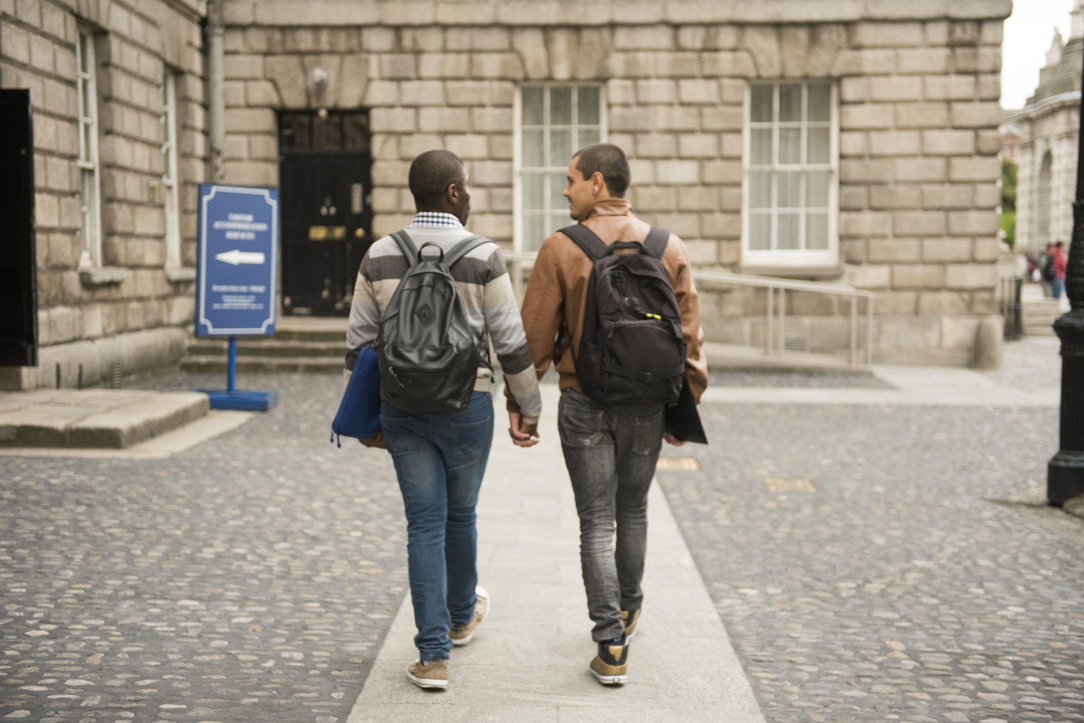 A college couple is holding hands