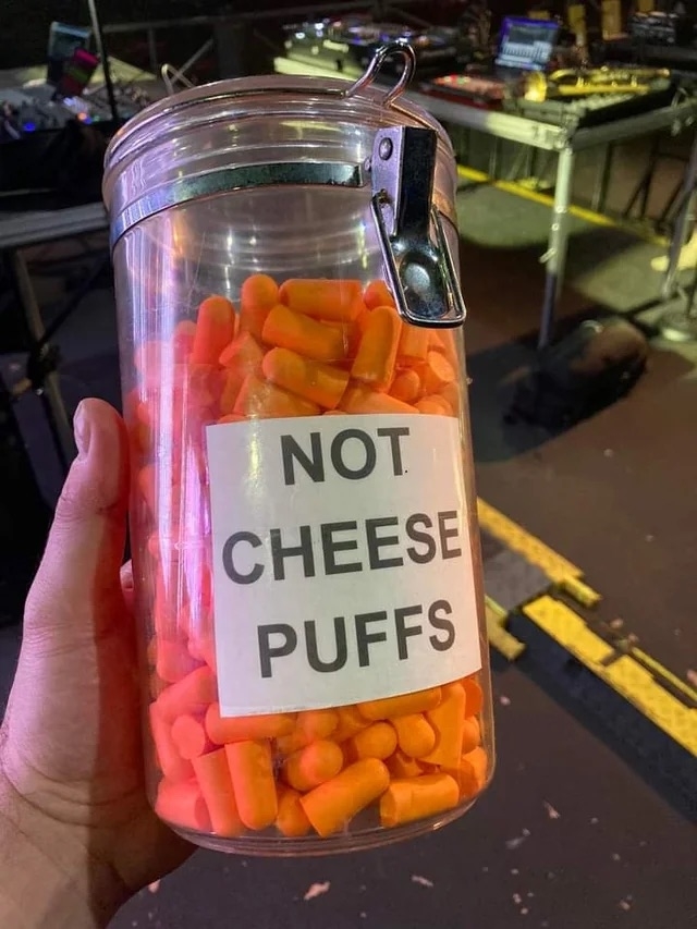 a container of orange ear plugs labeled &quot;not cheese puffs&quot;
