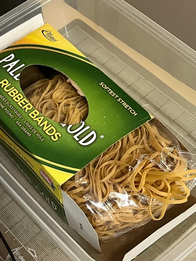 a container of rubber bands that looks like fettuccine pasta