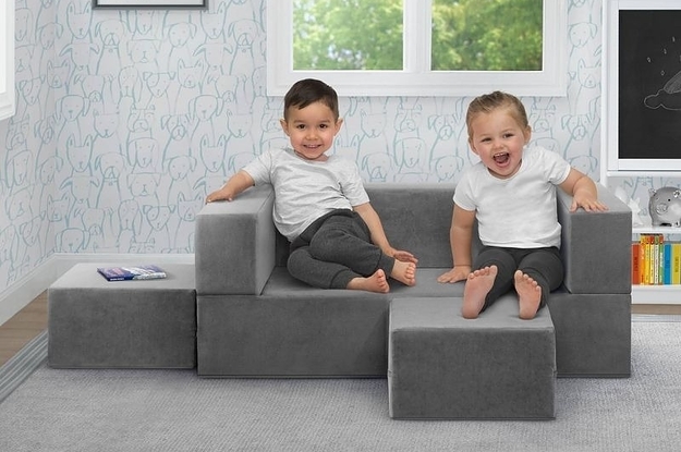 Kids sit on a convertible play couch