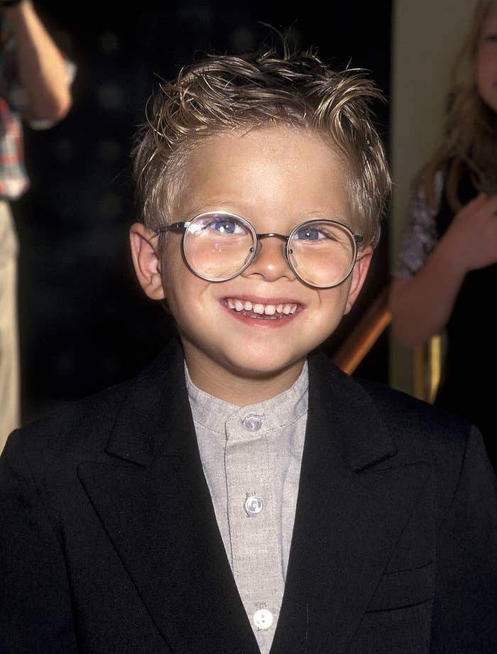 closeup of. him as a kid wearing circular glasses
