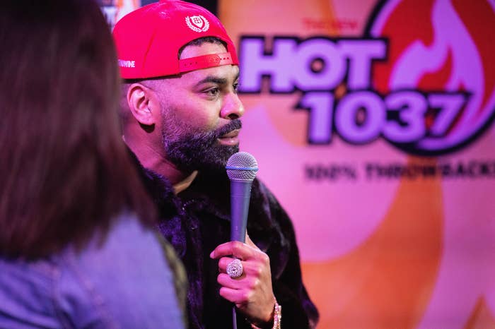 A closeup of ginuwine speaking into a mic