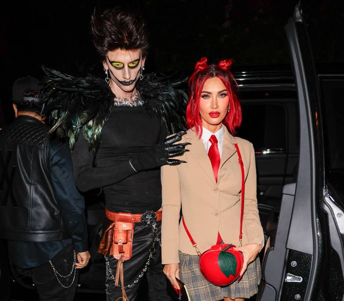 the couple during halloween getting out of their car in their costumes