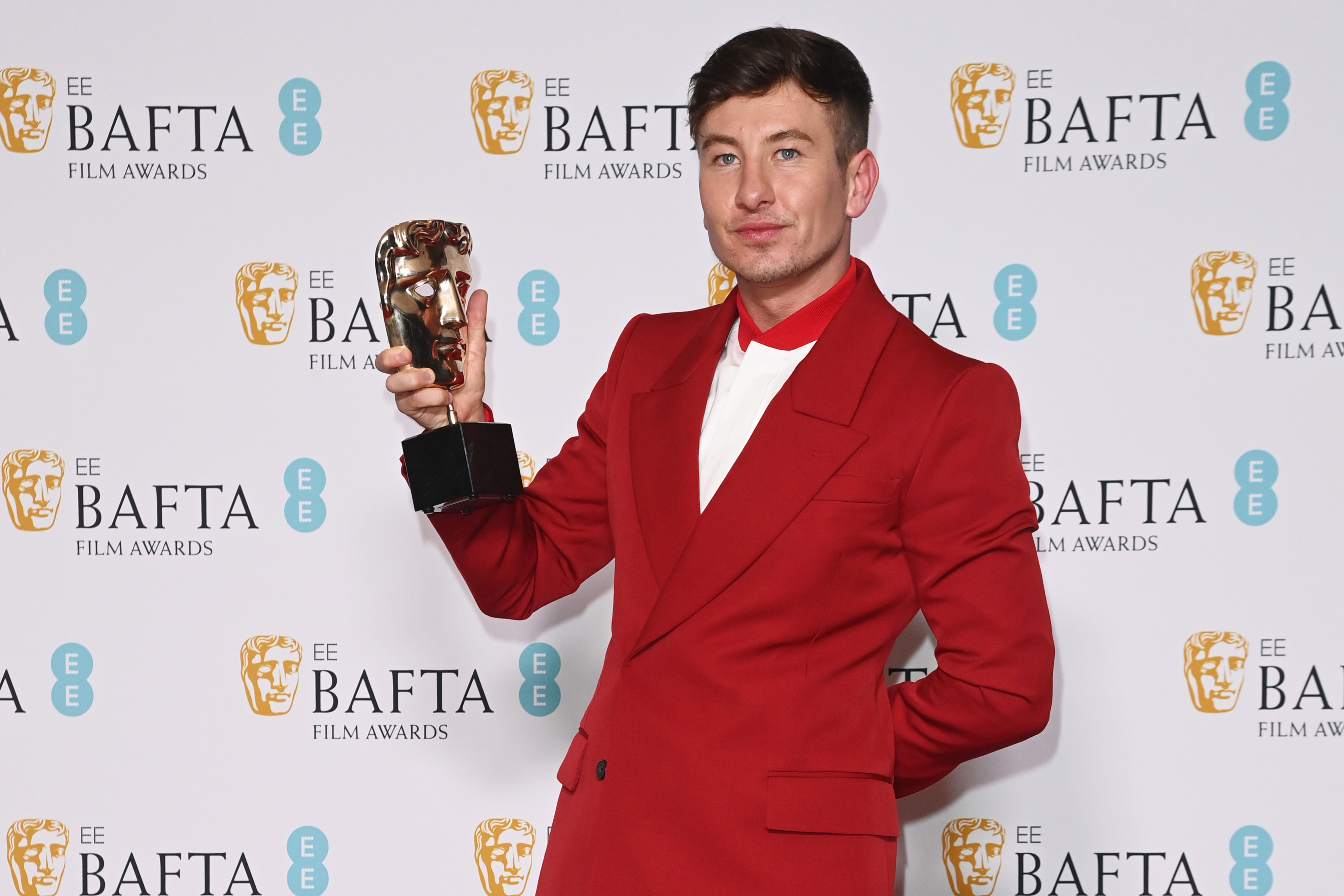 closeup of him holding up his BAFTA award