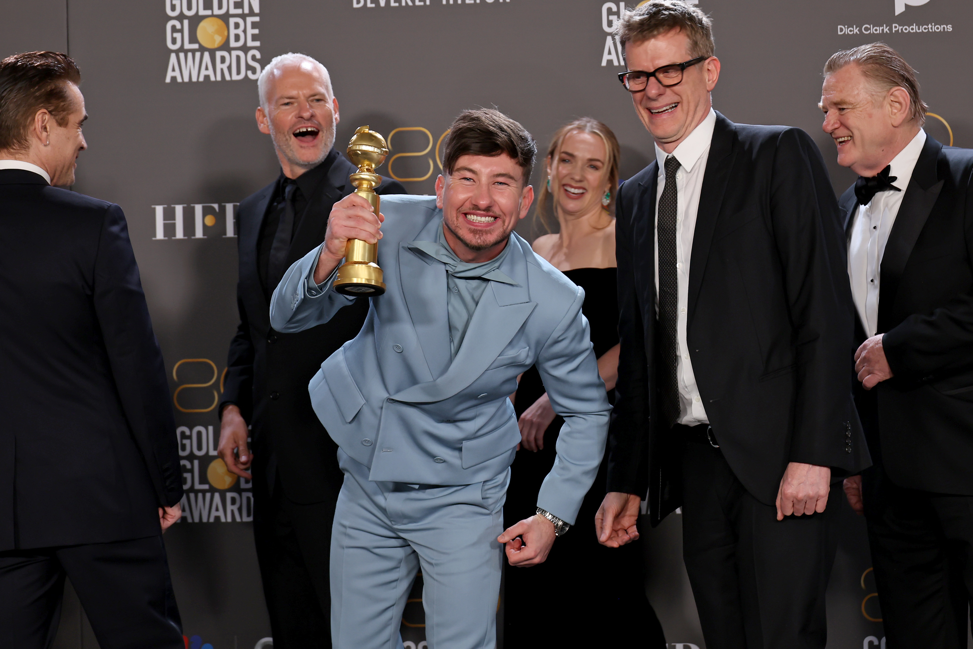 barry leaning into the camera and grinning wide with his award