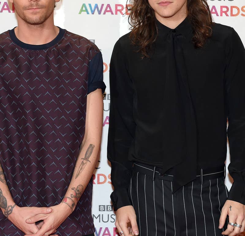 closeup of louis and harry standing next to each other at an event