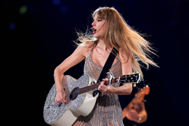 taylor playing guitar on stage