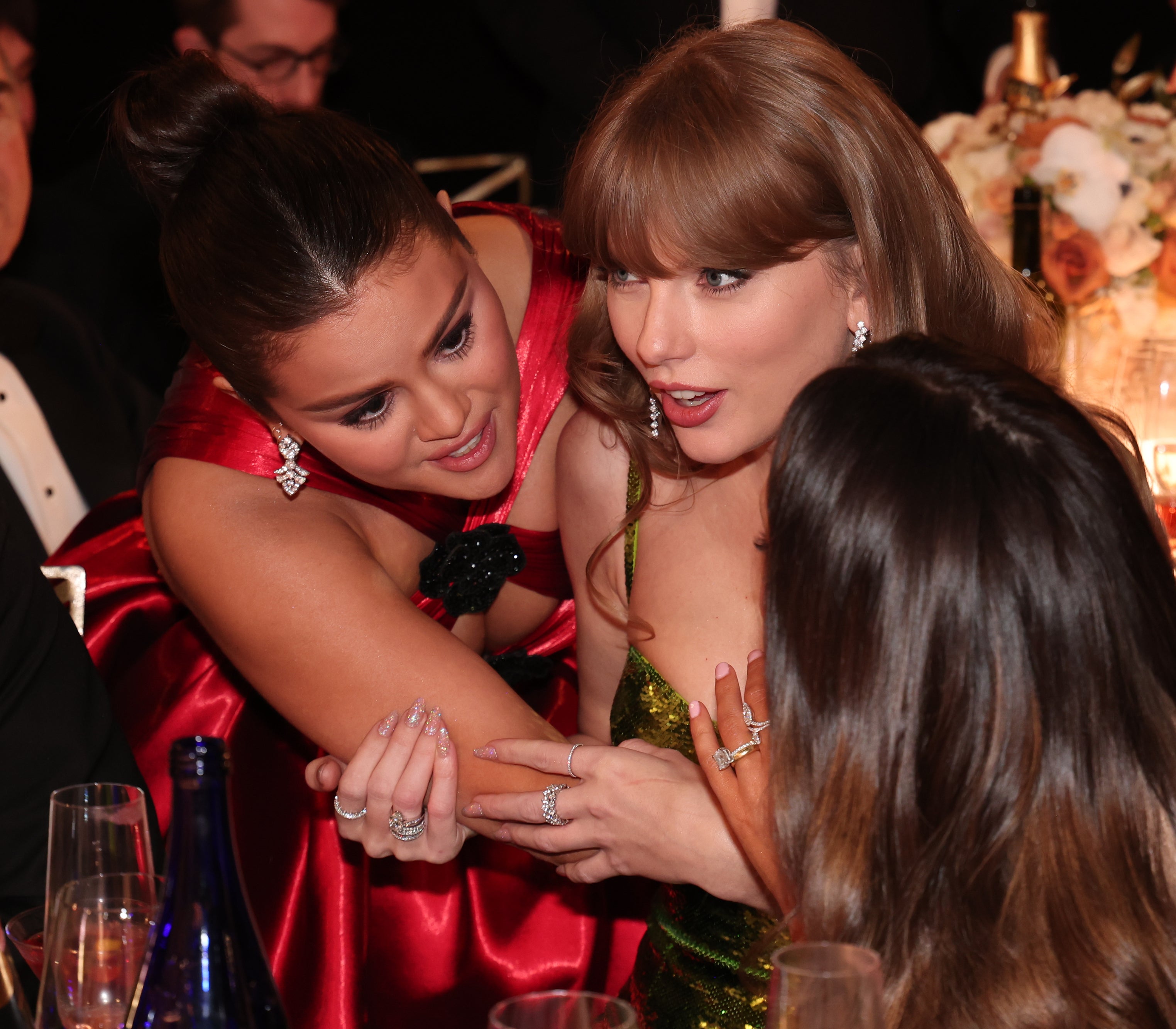 selena leaning over to talk and taylor&#x27;s face in shock