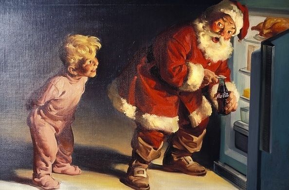 An advertisement featuring a kid catching Santa Claus with a glass of Coca-Cola