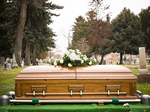 a coffin sitting in a graveyard