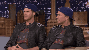 Will Ferrell and Chad Smith dressed exactly alike, sitting on a couch