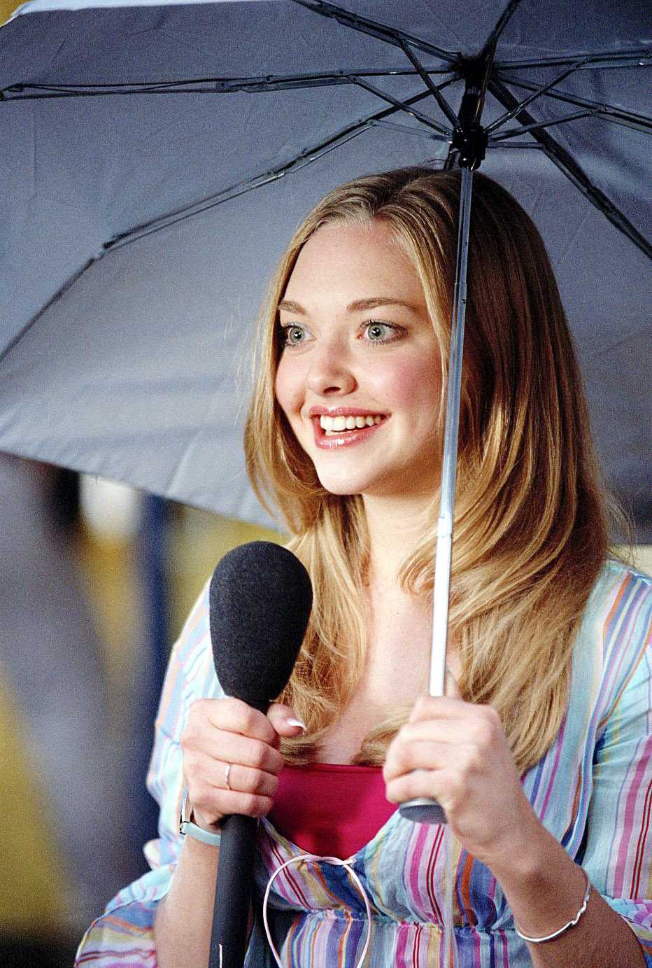 her character holding a mic and an umbrella