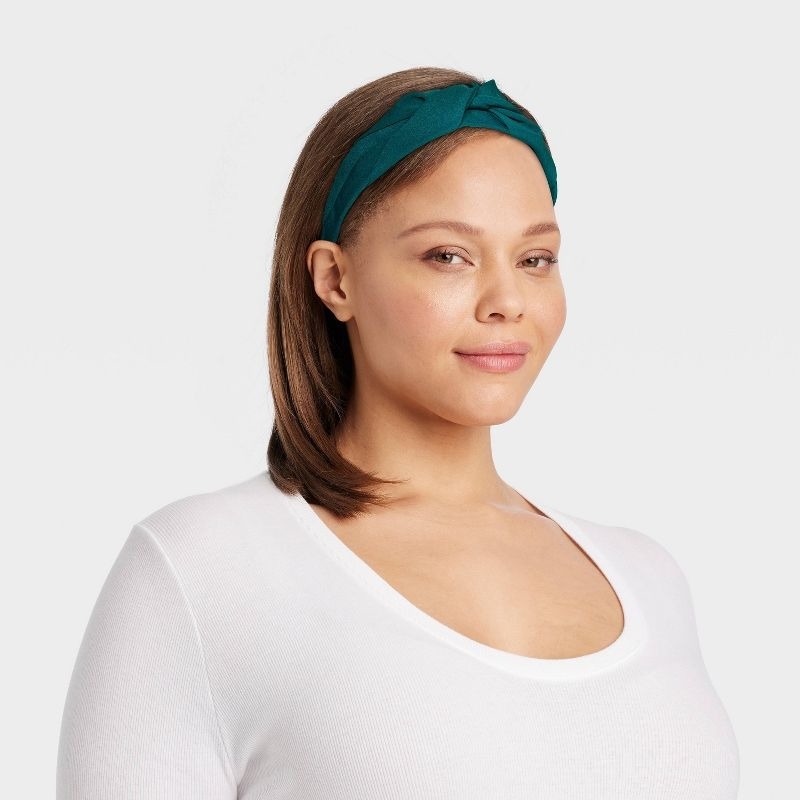 Model wearing the dark teal green headband