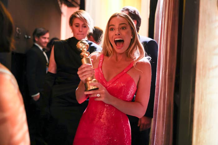 Close-up of Margot holding a Golden Globe Award