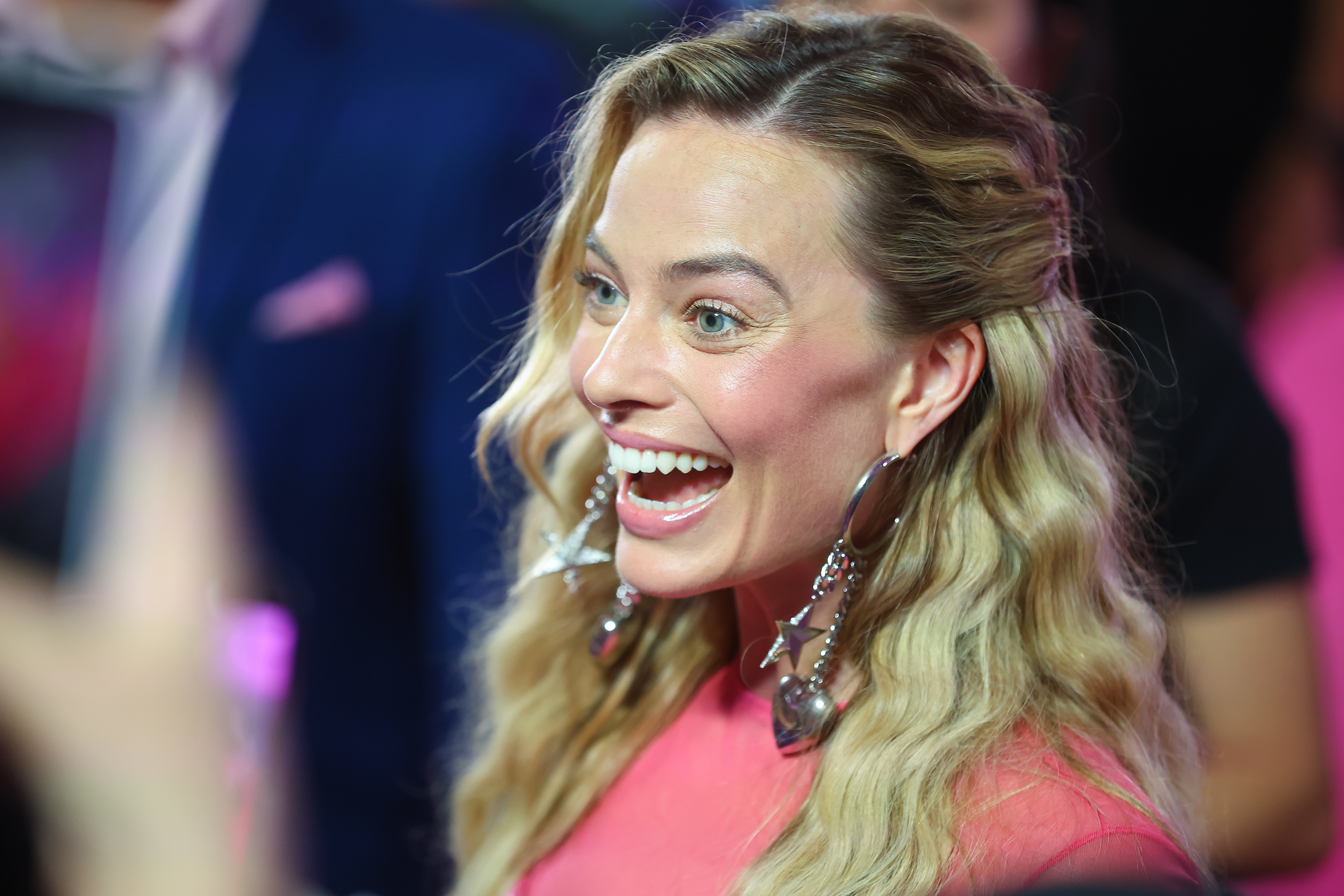 Close-up of Margot smiling at a media event
