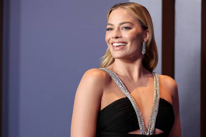Close-up of Margot smiling at a media event