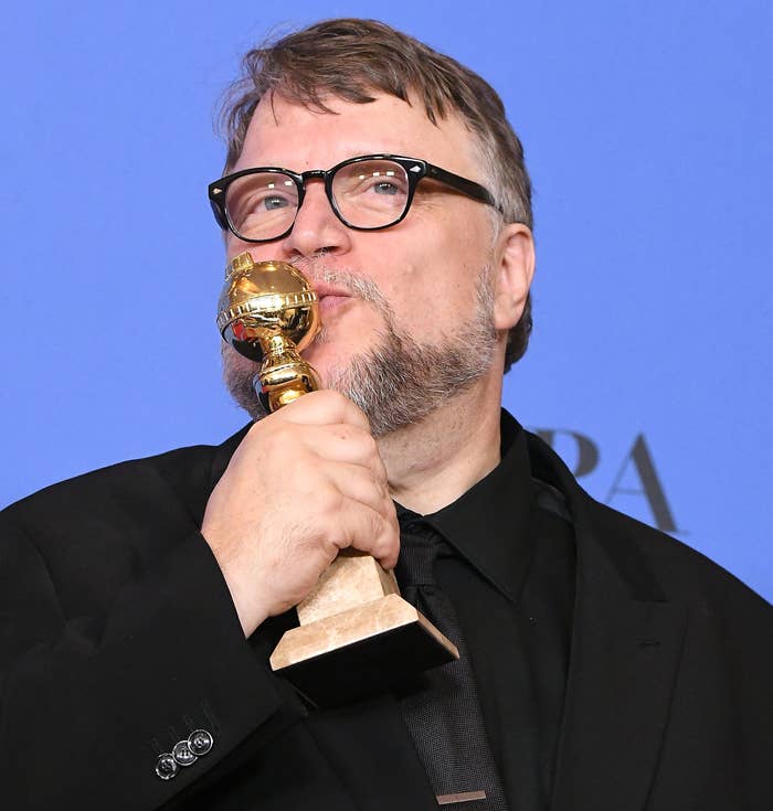 Close-up of Guillermo kissing an award