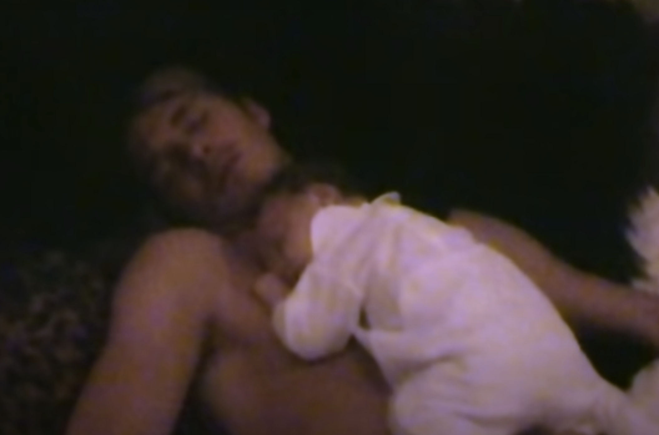 David lying down with baby Brooklyn on his bare chest
