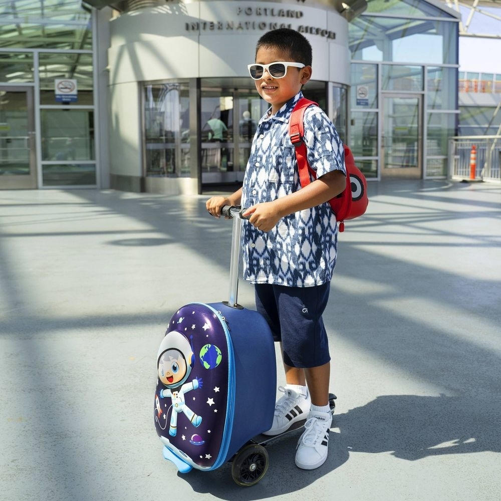 a child using the scooter suitcase
