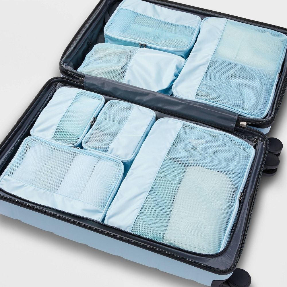 the packing cubes inside of a suitcase to show how they fit
