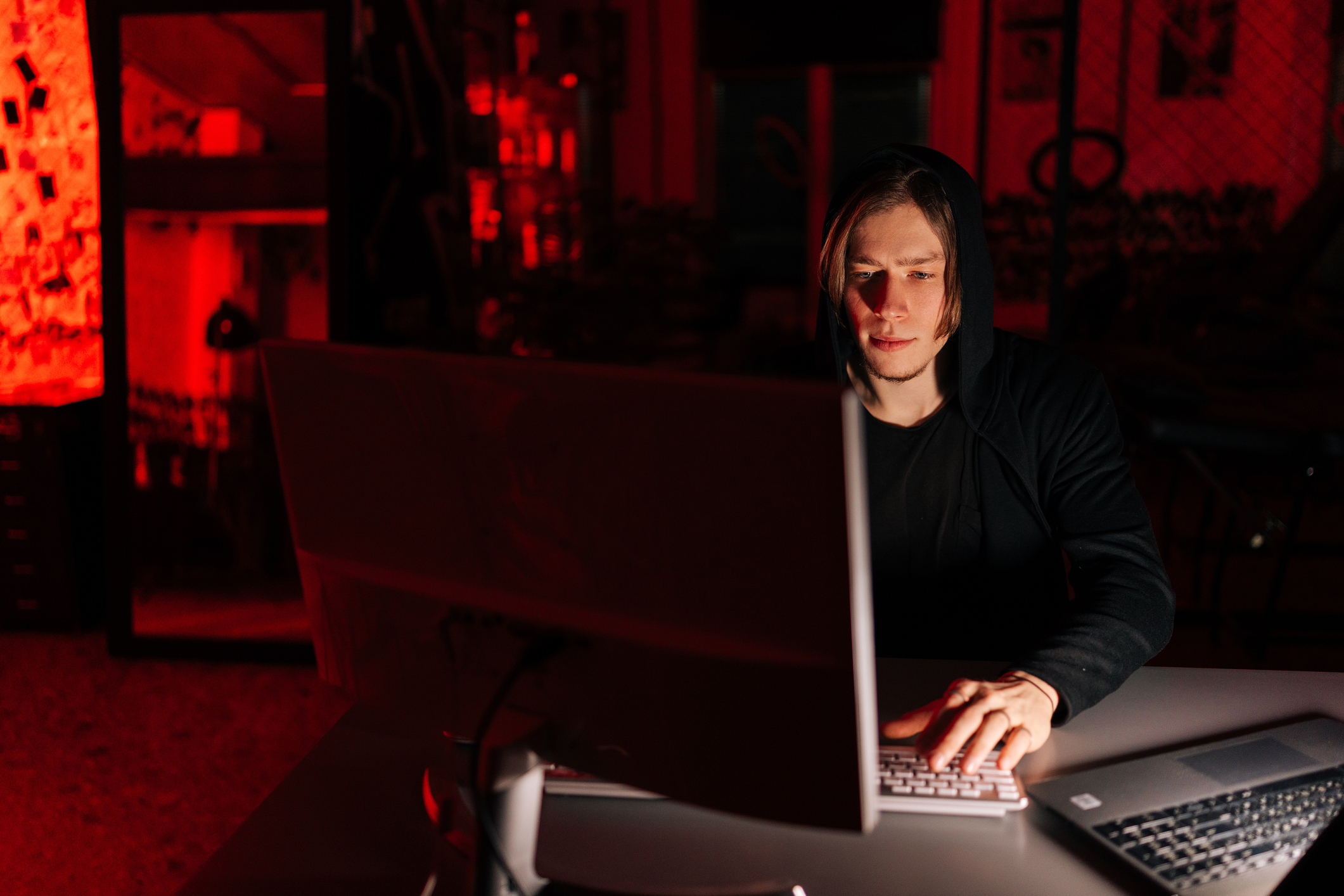 guy on his computer in a dark room