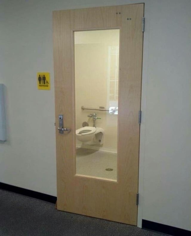a bathroom door with a window