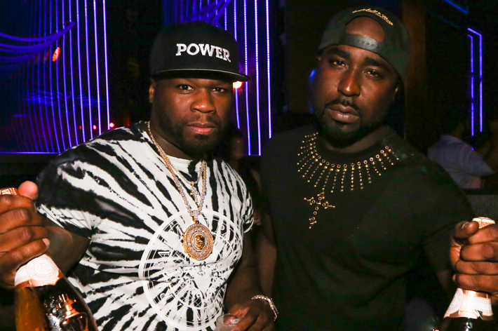 50 and buck are seen at a power event