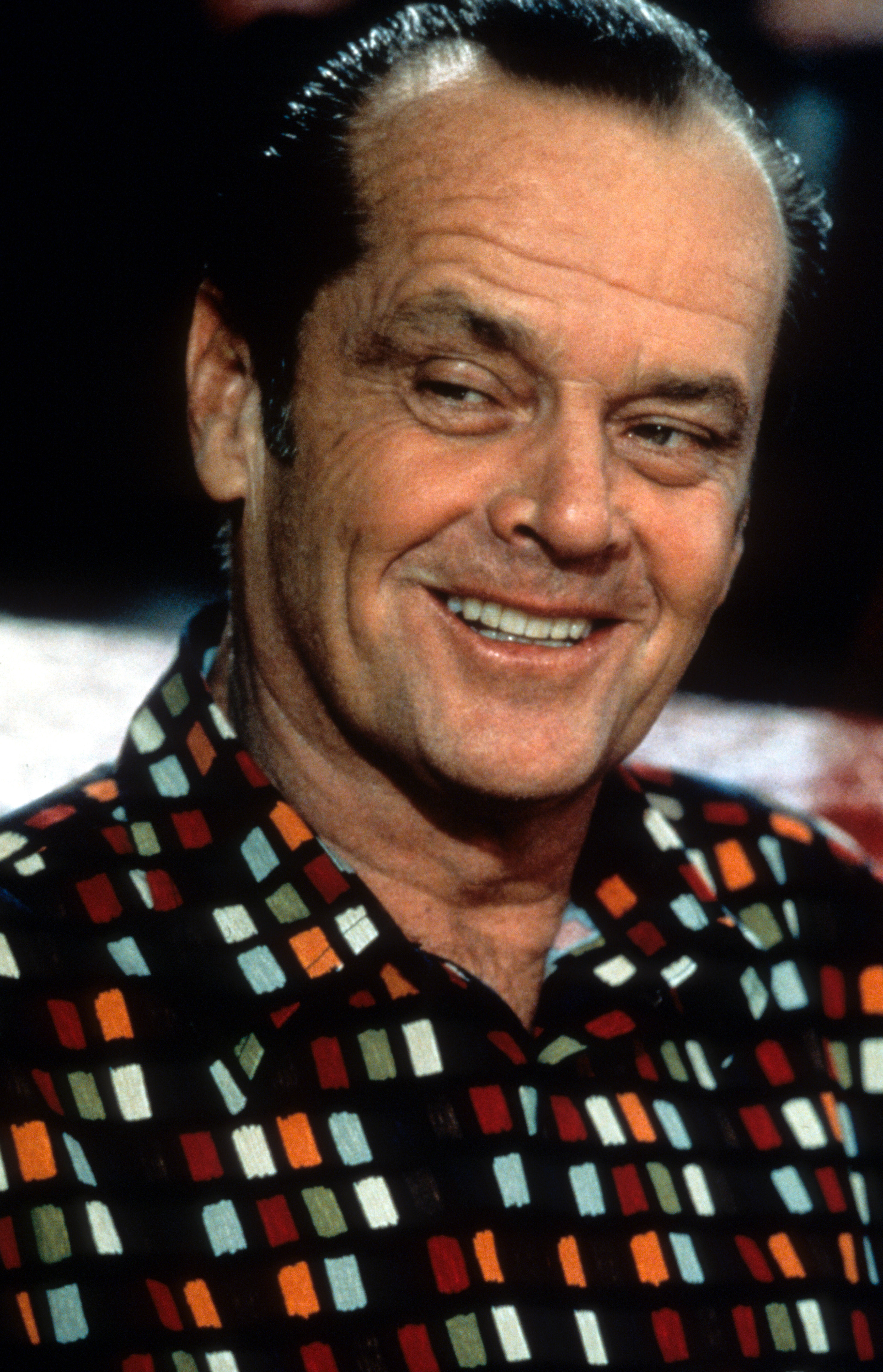 Close-up of Jack smiling and wearing a colorful shirt
