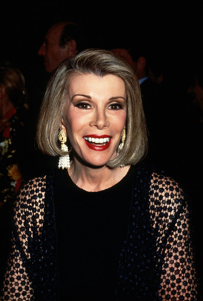 Close-up of Joan smiling and wearing a long-sleeved outfit