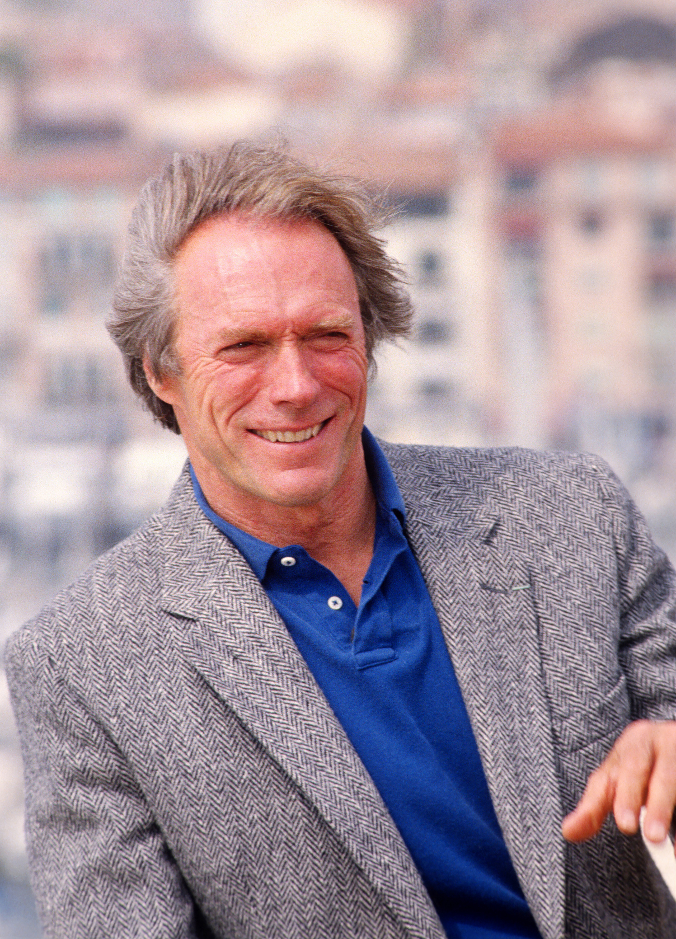 Close-up of Clint smiling in a jacket and shirt