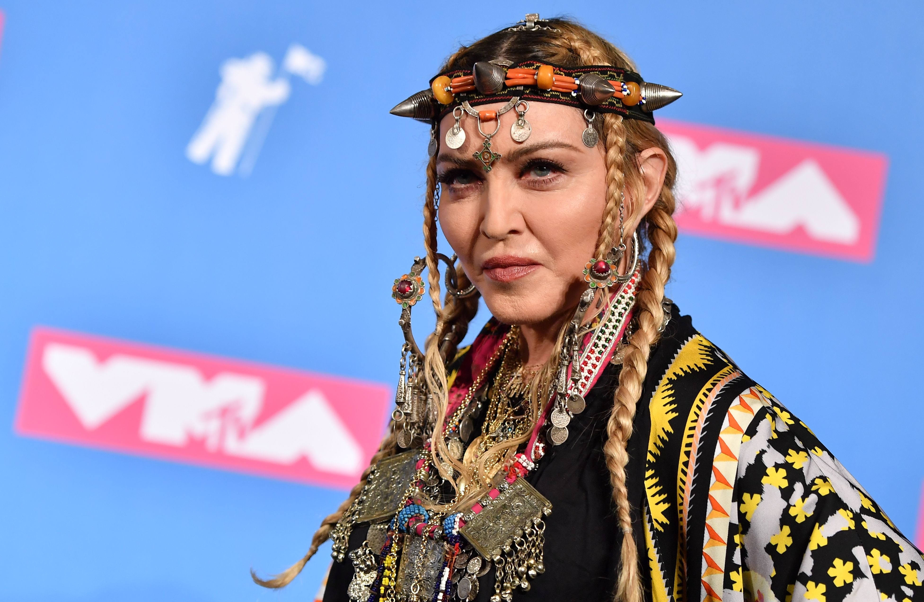 Close-up of Madonna in a colorful outfit and head gear at the VMAs