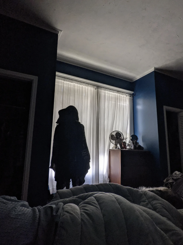 what looks like a human silhouette in front of a window