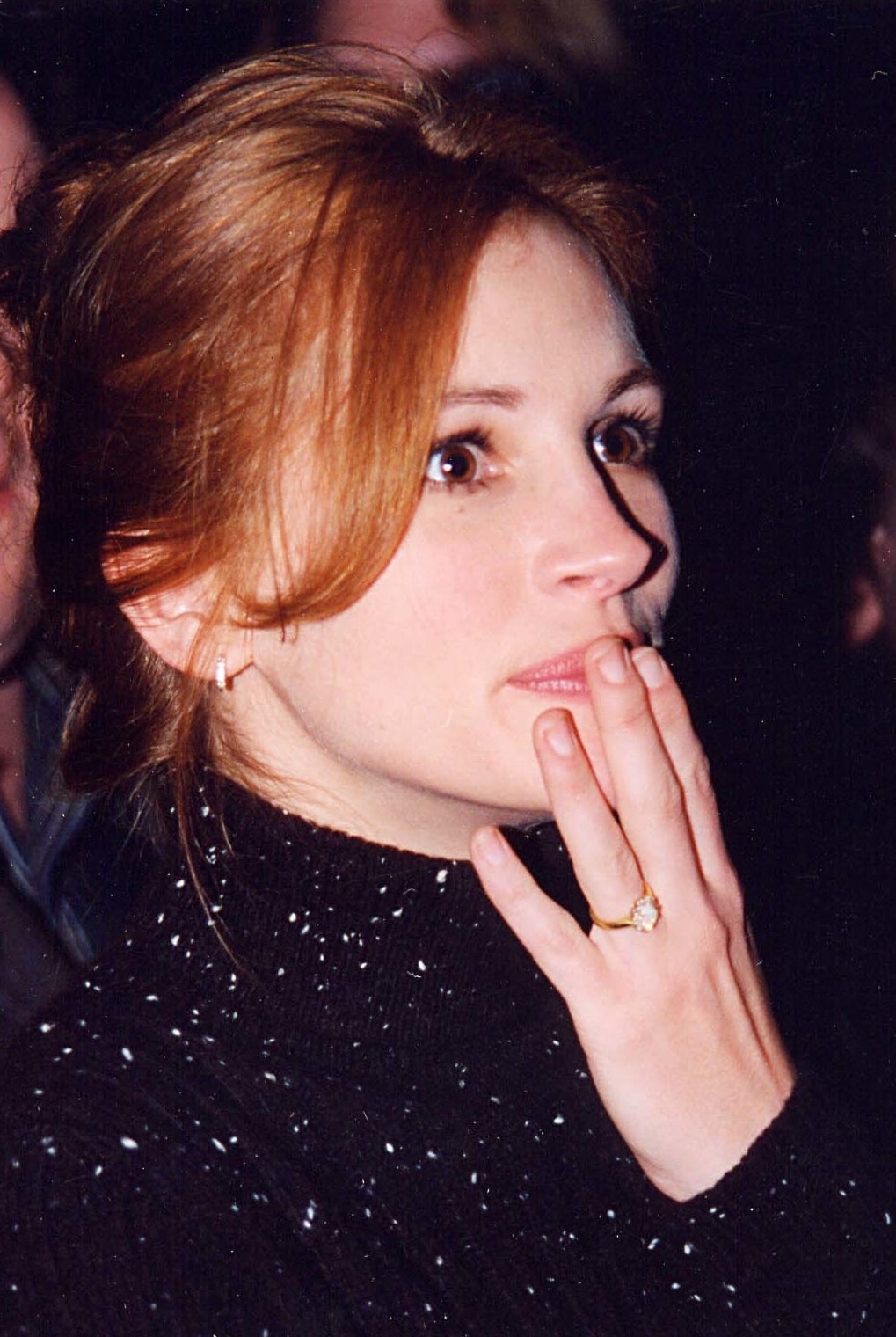 Close-up of Julia touching her face
