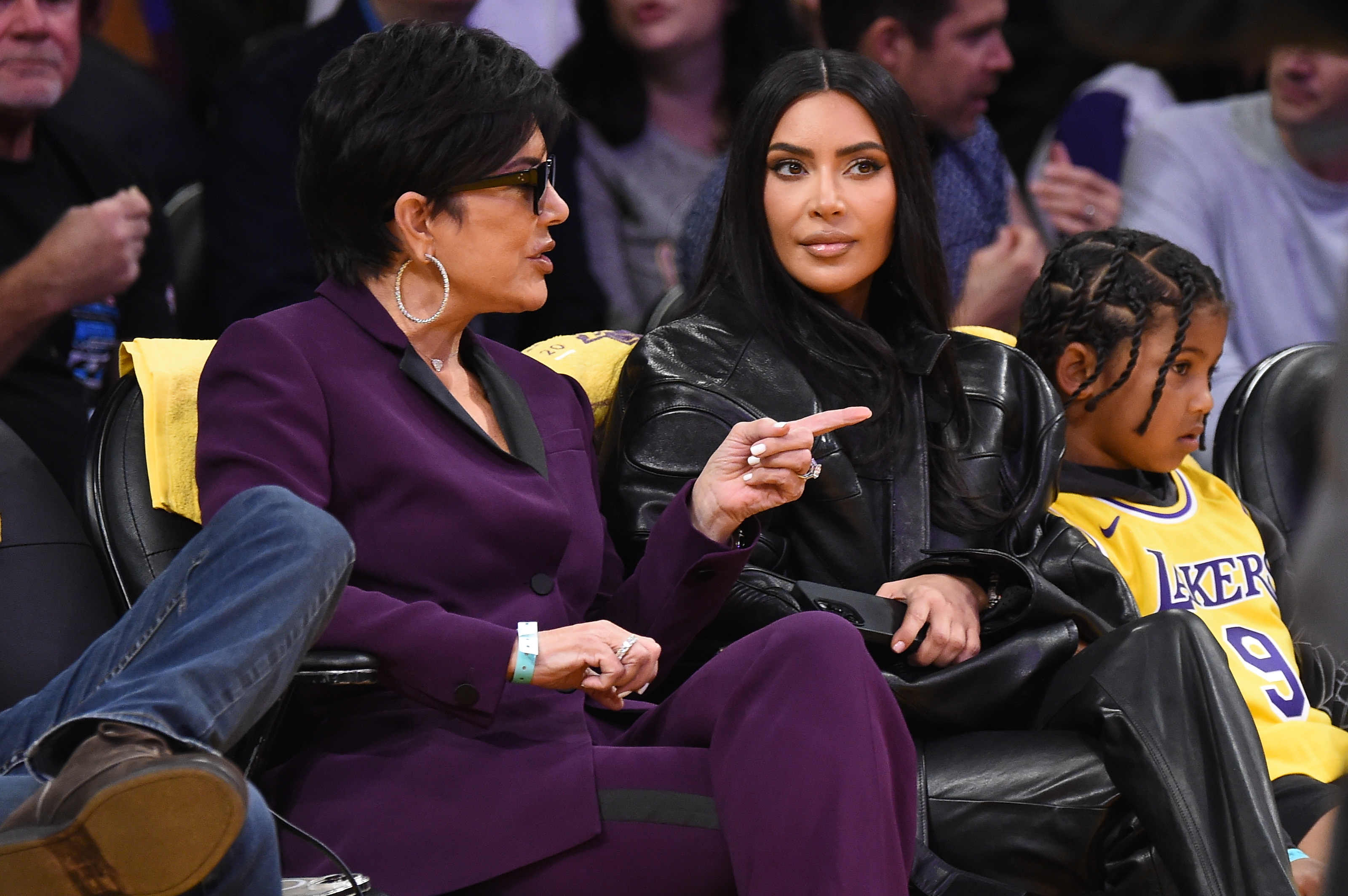 Kris and Kim with son Saint at an NBA game