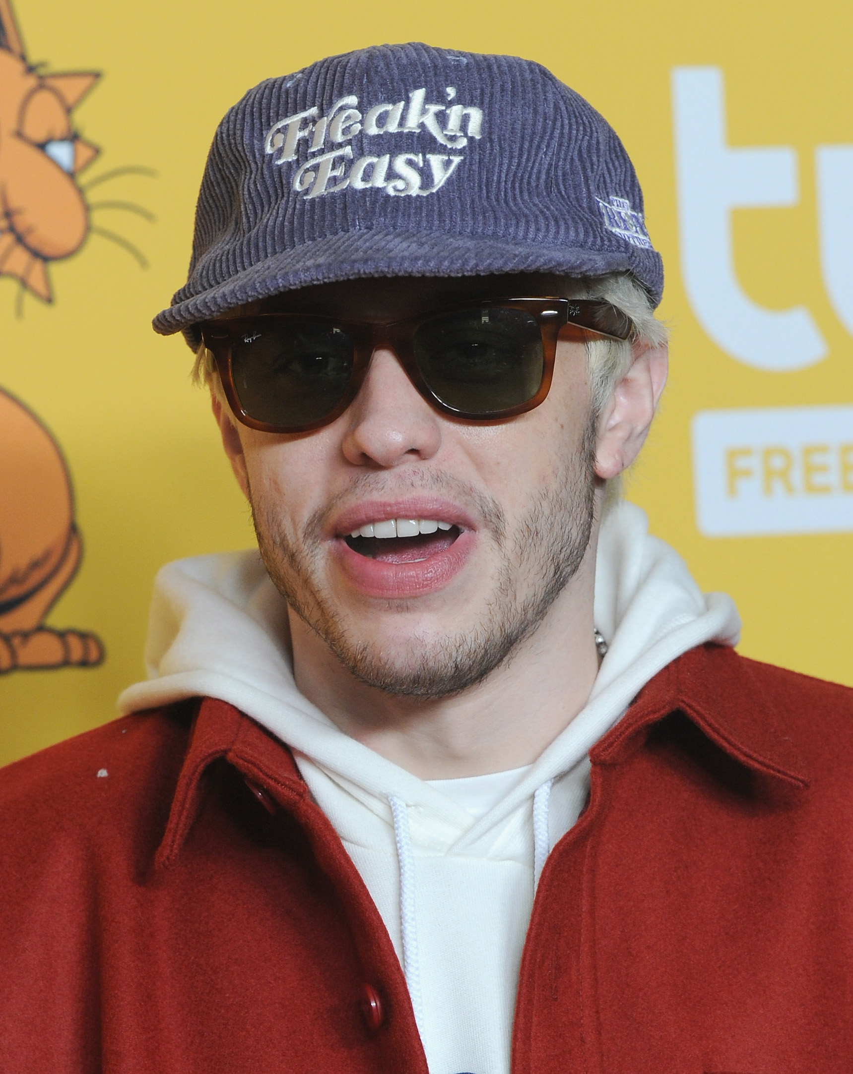 closeup of him in a cap and sunglasses