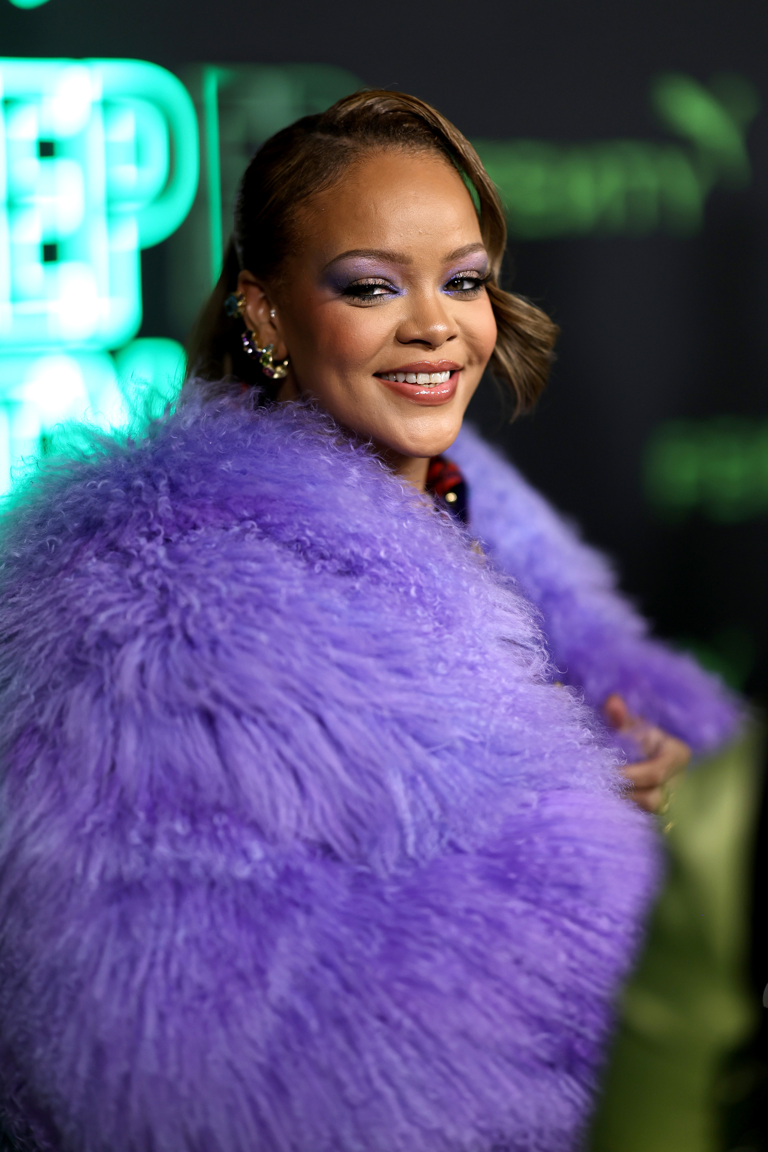 Close-up of RiRi smiling and wearing a furry stole