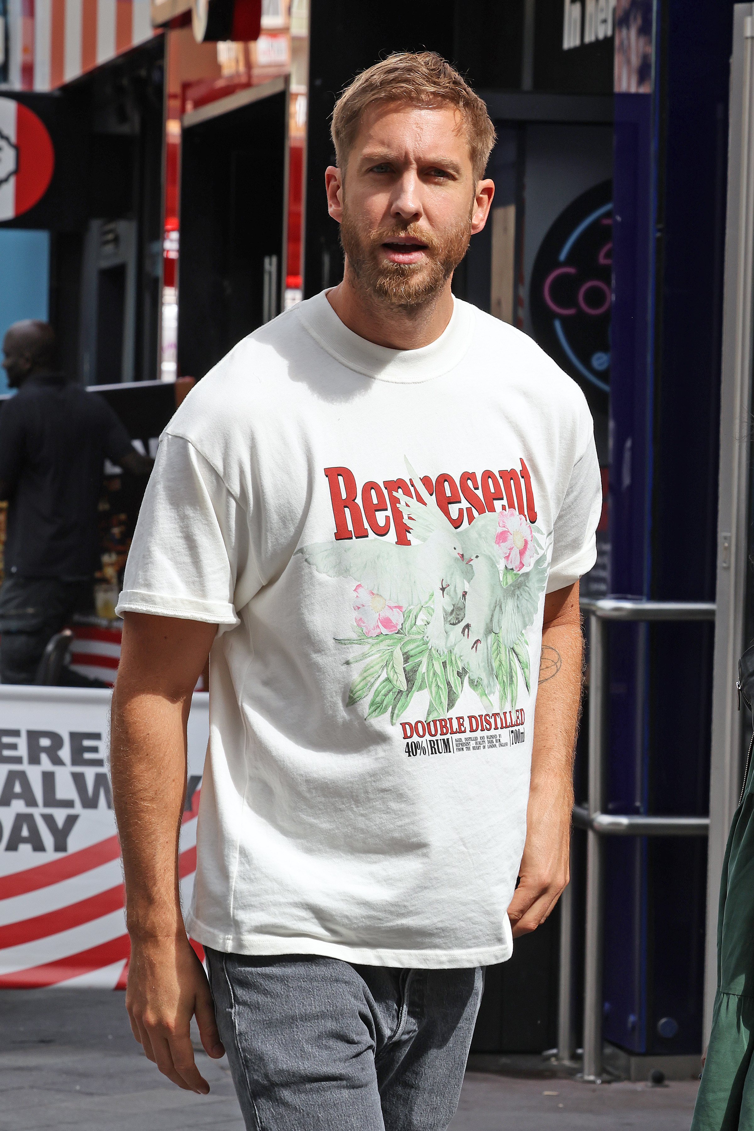 Close-up of Calvin/Adam in a &quot;Represent Double Distilled&quot; T-shirt and jeans