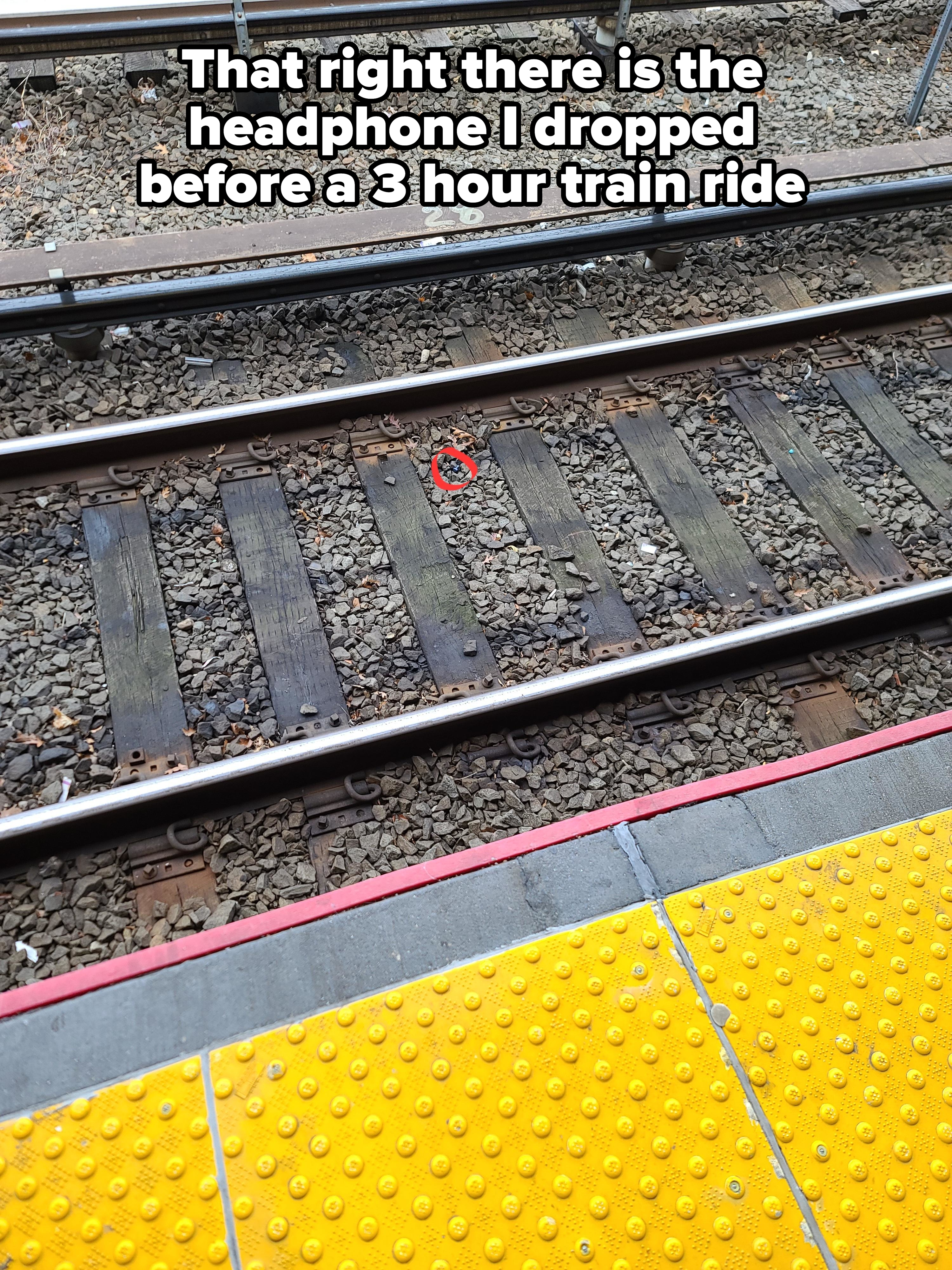 A headphone on a train track with caption, &quot;That right there is the headphone I cropped before a 3 hour train ride&quot;
