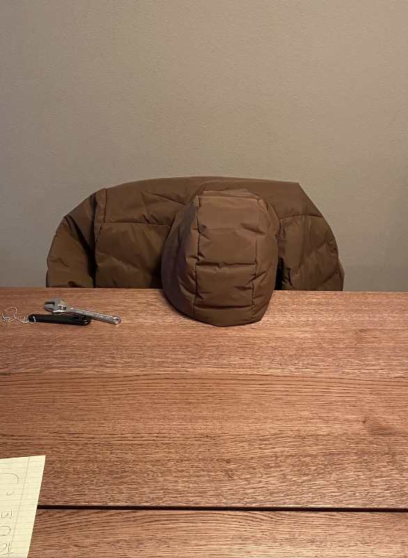 a jacket with the head down on a table