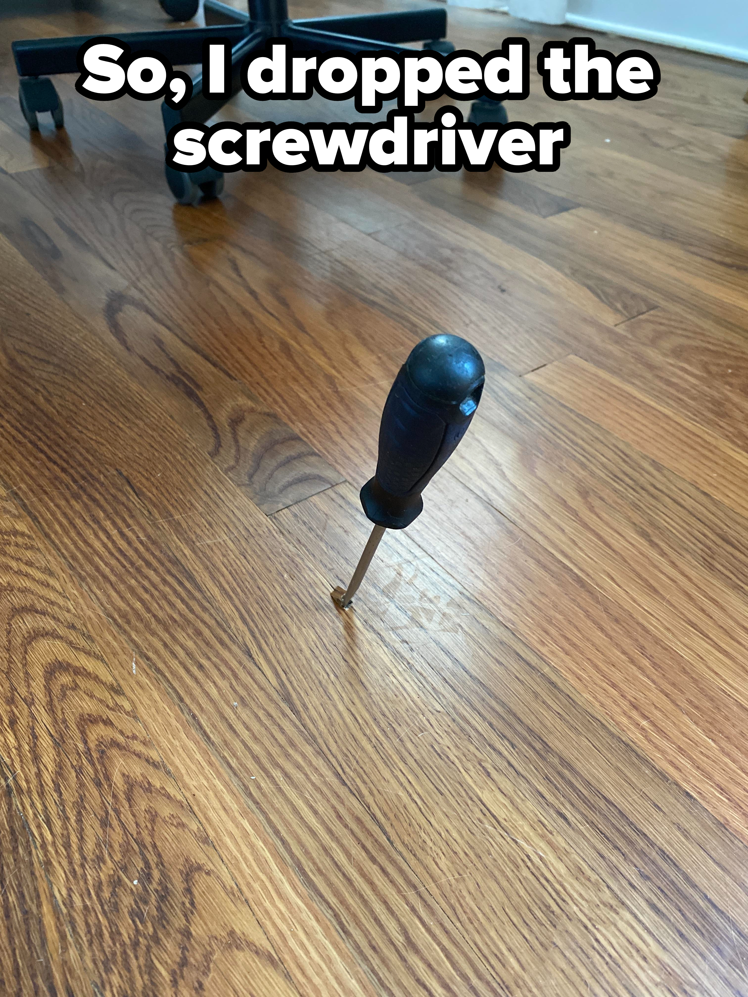 A screwdriver in a floorboard