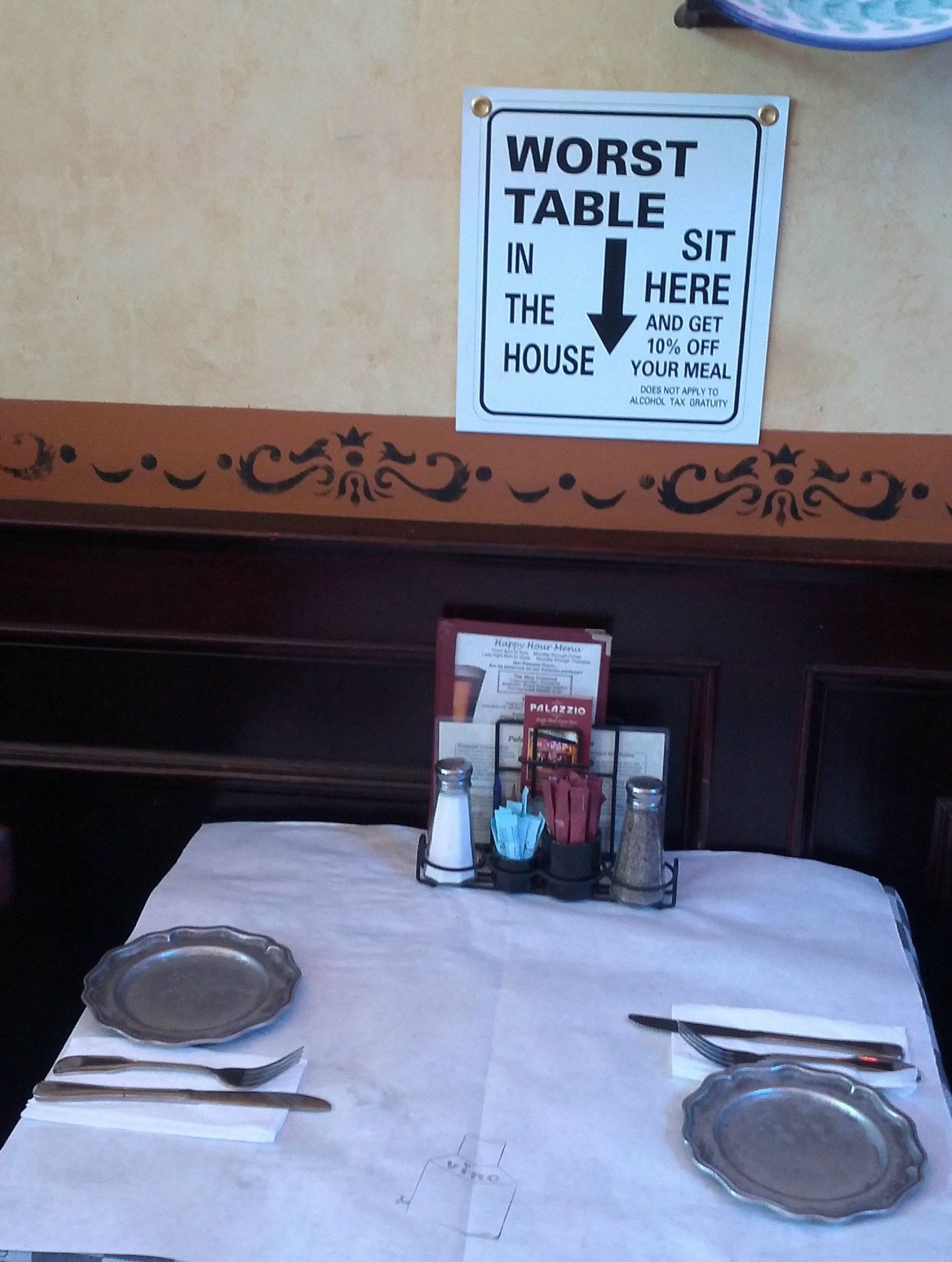 sign above a table says it's the worst table in the house