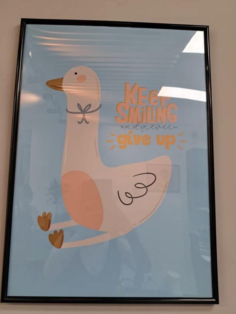 it looks like it reads keep smiling, give up