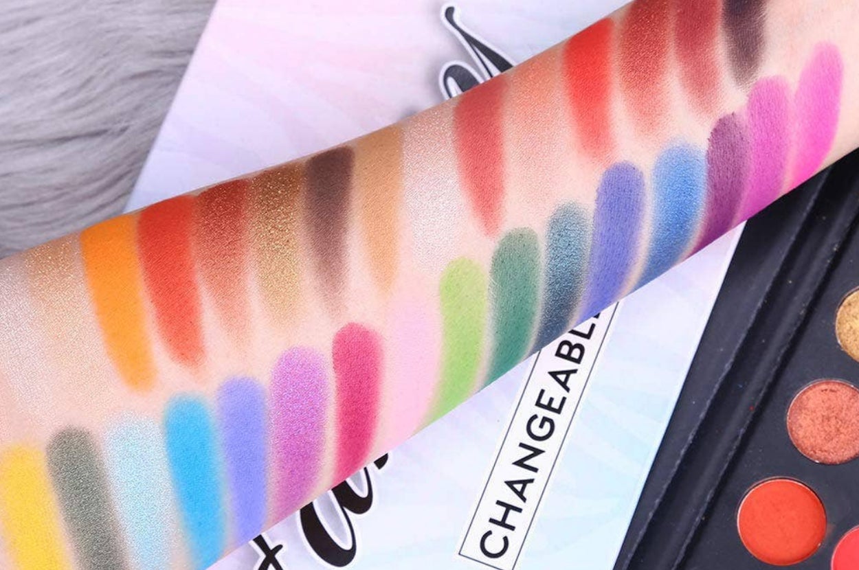 model's arm with swatches of forty eyeshadow colors